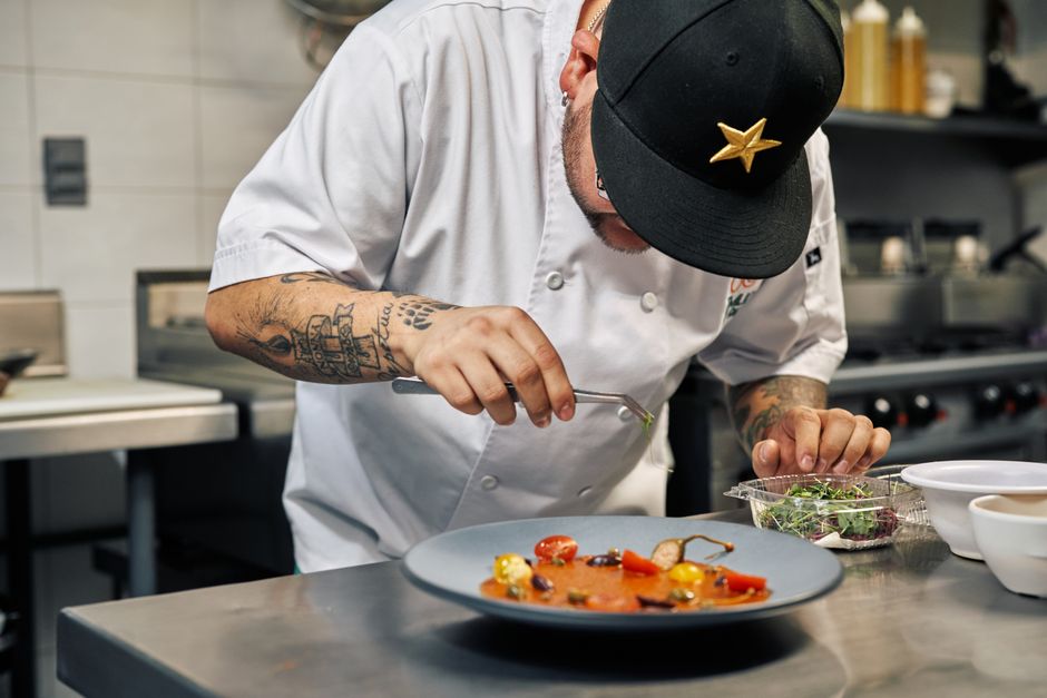 Professional chef carefully plating food